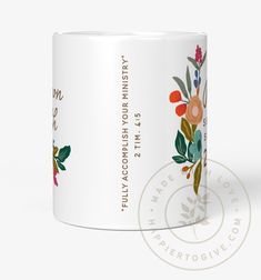 a white coffee mug with colorful flowers on it