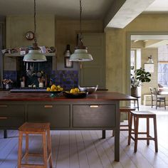 a kitchen with an island and stools in it