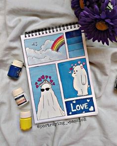 a notebook with pictures of polar bears on it next to some paint bottles and flowers