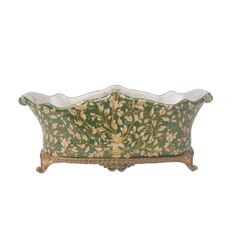 a green and white planter with gold trimmings on the bottom, sitting in front of a white background