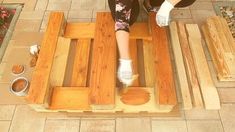 a woman standing on top of wooden pallets with her feet in the air,