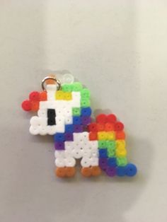 a keychain made out of legos on a white surface with a small pixel