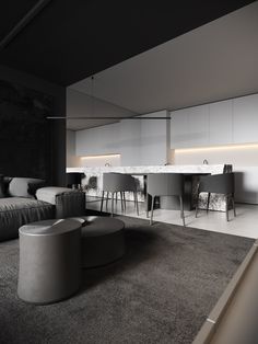 a living room filled with furniture next to a kitchen and dining area in black and white