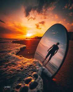 a man standing on the beach in front of a mirror