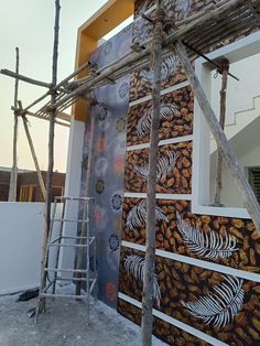 an unfinished house that has been decorated with wallpapers and bamboo sticks on the roof