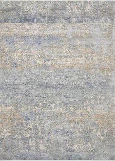 an area rug with blue, beige and grey colors on the floor in front of a white background