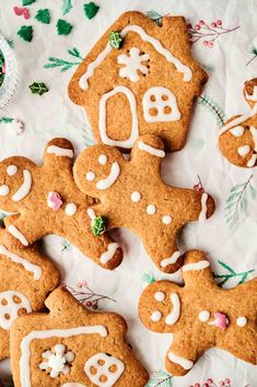 gingerbread cookies decorated with icing and sprinkles on a white tablecloth