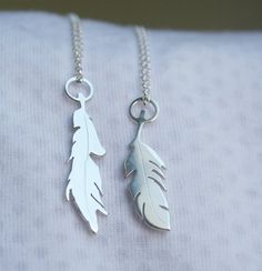 This listing price is for 1 silver feather pendant.  Please choose which feather you prefer (left or right from 1st pic), or you can order both.-d e s c r i p t i o n-These little feathers are handmade from scratch using traditional metalsmithing techniques.The sterling silver is melted & rolled into sheet and the feather shapes are hand cut with my saw and engraved by me.These petite pendants measure roughly 2.5cm tall.If you order more than one, I will provide different length chains for a lay Silver Sterling Silver Necklaces With Feathers, Silver Feathered Sterling Silver Necklaces, Silver Feather Pendant Jewelry, Silver Feather Necklace, Tropical Jewelry, Feather Necklace, Hood Ornaments, Feather Pendant, Silver Feather