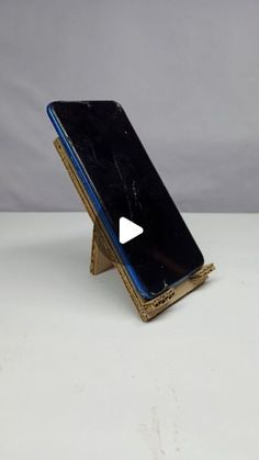 an old cell phone sitting on top of a stand with a video player in front of it