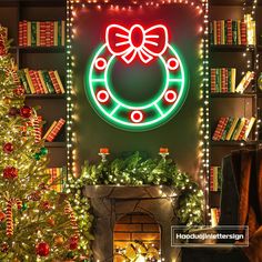 a christmas tree in front of a lit fireplace with a wreath on the wall above it