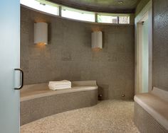 a bathroom with a circular shower and two sinks