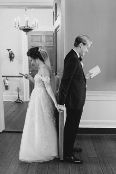 a bride and groom standing in front of the door to their wedding reception at home