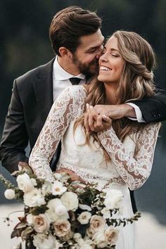 a bride and groom embracing each other