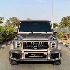 the front end of a silver mercedes g - class suv