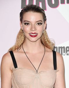 a woman with blonde hair wearing a bra and red lipstick on her lips is posing for the camera