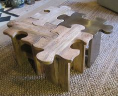 a table made out of puzzle pieces sitting on top of a carpeted floor next to a couch