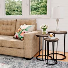 a living room scene with focus on the couch and coffee table in front of the window