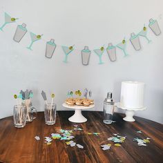 a wooden table topped with desserts and confetti on top of it's sides