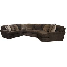 a large sectional couch with pillows on the top and bottom corner, in brown fabric