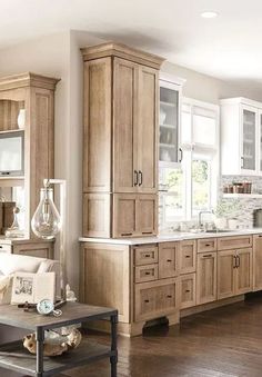 a kitchen filled with lots of wooden cabinets