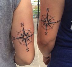 two people with compass tattoos on their arms