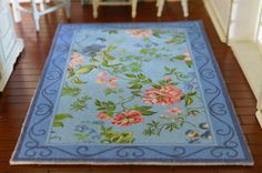 a blue area rug with flowers on it