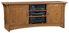 a wooden entertainment center with two stereos