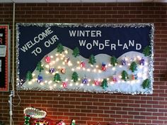 a bulletin board with christmas lights on it in front of a brick wall that reads welcome to our wonderful wonderland land