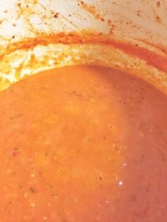 a pot filled with soup sitting on top of a stove