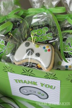 some cookies are in a green box with a thank you sign on it and a video game controller cookie