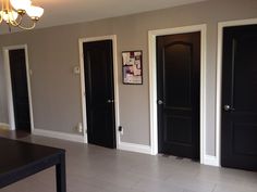 a room with three black doors in it