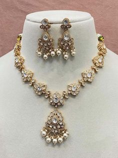 Classic Timeless Dainty Gold Plated Fine Polki, American Diamond Necklace Set in Gold finish adjustable via drawstring. High Quality raw materials used with high class polishing.  Perfect to go with any ethnic Indian / IndoWestern or Western wear.  💥 Necklace Length: 25" & adjustable.  WHAT GOES IN  👉🏻High Quality Raw materials and finishing guarantee. 👉🏻Brass is used as base metal gold finish. ✅Check our collection here https://www.etsy.com/shop/KKsCulture ✅Send us an email if you need help! kksculture @ gmail.com | Contact Us 732-325-2222 Elegant White Adjustable Kundan Necklace, Festive Adjustable White Necklace, Adjustable Kundan Necklaces For Party, Elegant Adjustable Kundan Necklace, White Kundan Long Necklace, Elegant Adjustable Silver Kundan Necklace, Polki Diamond Necklace, American Diamond Necklace Set, American Diamond Necklaces