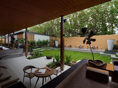 an outdoor living area with chairs and tables