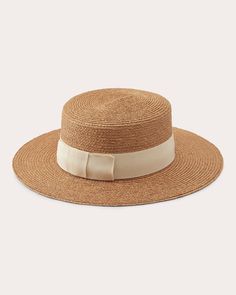 Handcrafted from braided raffia, the Gracie hat is shaped with a flat top and crown that give nod to traditional boaters. The bow-tied ribbon trim is decorated with a goldtone seed logo for luxury appeal. Inner adjustable band Flat crown Grosgrain ribbon trim with bow Logo detail UPF 50+ Outer: 100% braided raffia Trim: 50% cotton, 50% FSC-certified viscose Spot clean Materials sourced from Madagascar Made in Sri Lanka Measurements Brim: 3in Crown height: 4in Ribbon width: 1.5in Seed Logo, Bow Logo, Tied Ribbon, Helen Kaminski, Crown Heights, Cleaning Materials, Ribbon Trim, Flats Top, Grosgrain Ribbon