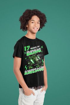 a young boy wearing a t - shirt with the words being awesome on it