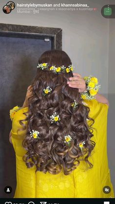 a woman with long hair and flowers in her hair