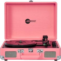 an open pink suitcase with a record player in the center and two speakers on each side