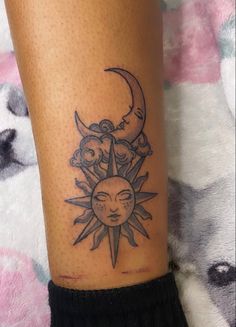 a sun and moon tattoo on the leg