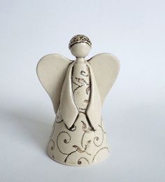 an angel figurine with a tiara on it's head and wings