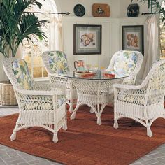 a dining room table with chairs and a rug