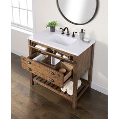 a bathroom vanity with two drawers and a mirror on the wall above it is shown