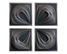 four square metal artwork pieces in black and white, each with an abstract design on them