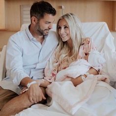 a man sitting next to a woman in a hospital bed