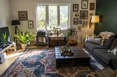 a living room filled with furniture and a large rug on top of a wooden floor