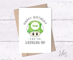 a card with the words happy birthday to you've level up on it and an image of a mushroom