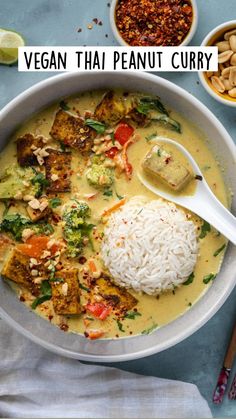 a bowl of food with rice, broccoli and tofu on the side