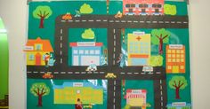 a child's bulletin board with cars and buildings on it