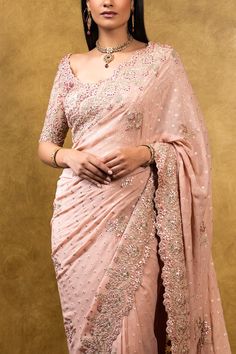 Editor's Note Rose Pink Chiffon Booti Saree With Delicate Gota Work Color: Pink Fabric: Chiffon Components: Sari & Blouse Care: Dry Clean Only About the Designer Nitika Gujral’s journey with designing clothes started almost four decades back while she was still in high school and held her first exhibition for family and friends. Making clothes has been a part of her life ever since. Semi-stitched Georgette Blouse For Wedding, Pink Georgette Blouse With Sheer Dupatta, Formal Georgette Blouse With Mirror Work, Elegant Pink Blouse With Sheer Dupatta, Elegant Chiffon Blouse With Zari Work, Chiffon Blouse With Traditional Drape For Wedding, Traditional Drape Chiffon Blouse For Wedding, Elegant Semi-stitched Chiffon Blouse, Silk Chiffon Pre-draped Saree For Wedding