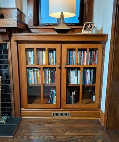 a wooden bookcase with many books in it