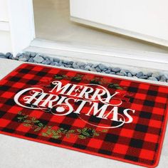 a red and black door mat that says merry christmas